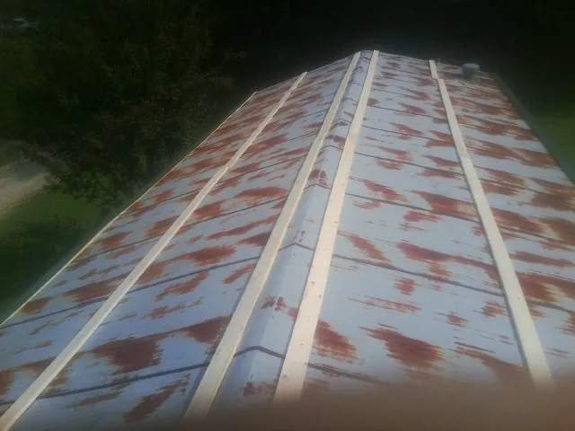 Rusted metal roof panels with new wood purlins before replacement — Storm Damage Roof Repair in Oradell by Roofing Brothers